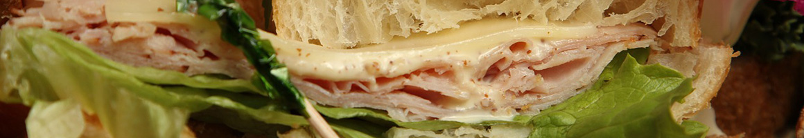 Eating Deli Sandwich at Marathon Deli restaurant in Ashland, MA.